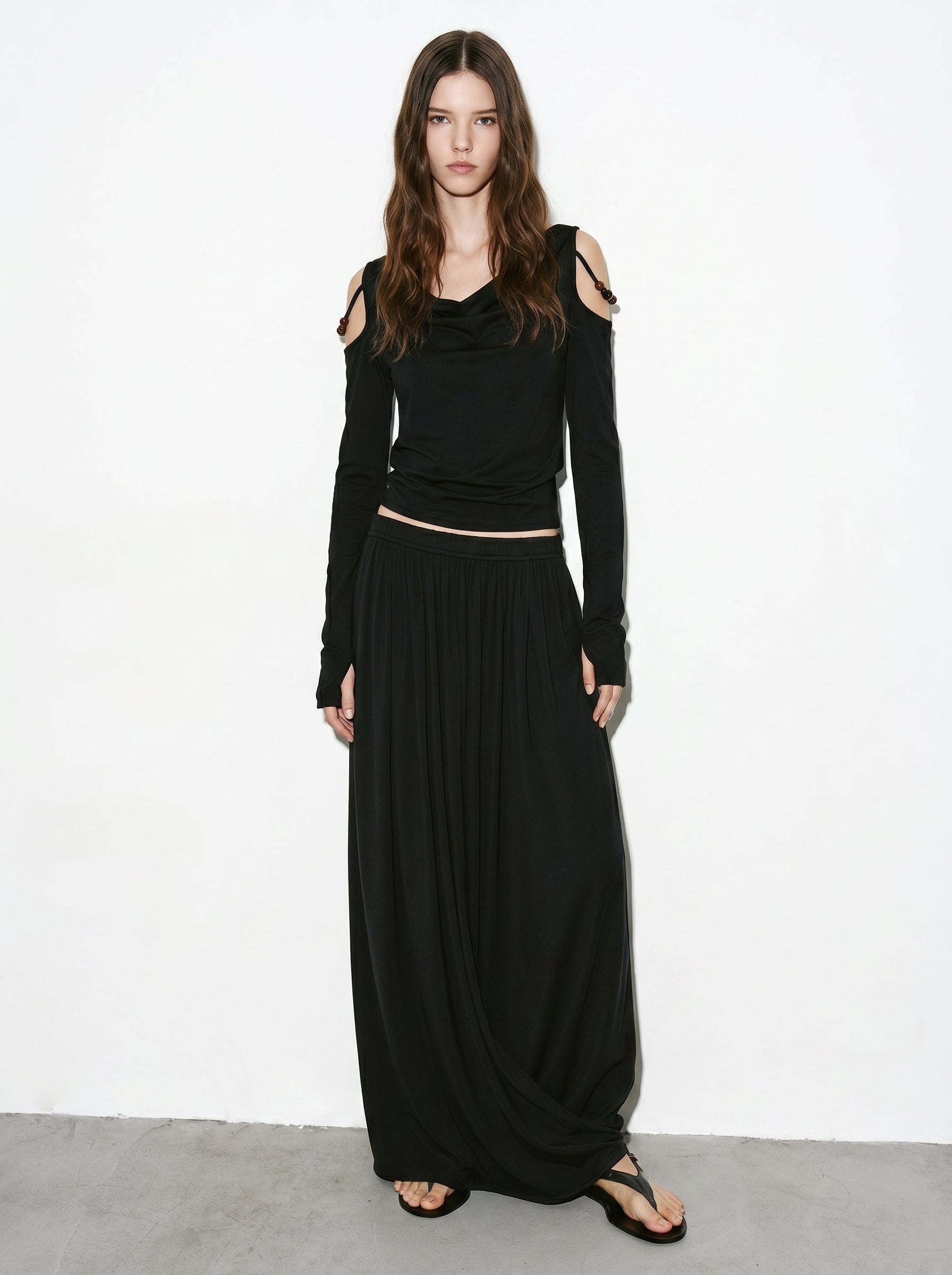 Black off shoulder long sleeve top styled with draped maxi skirt