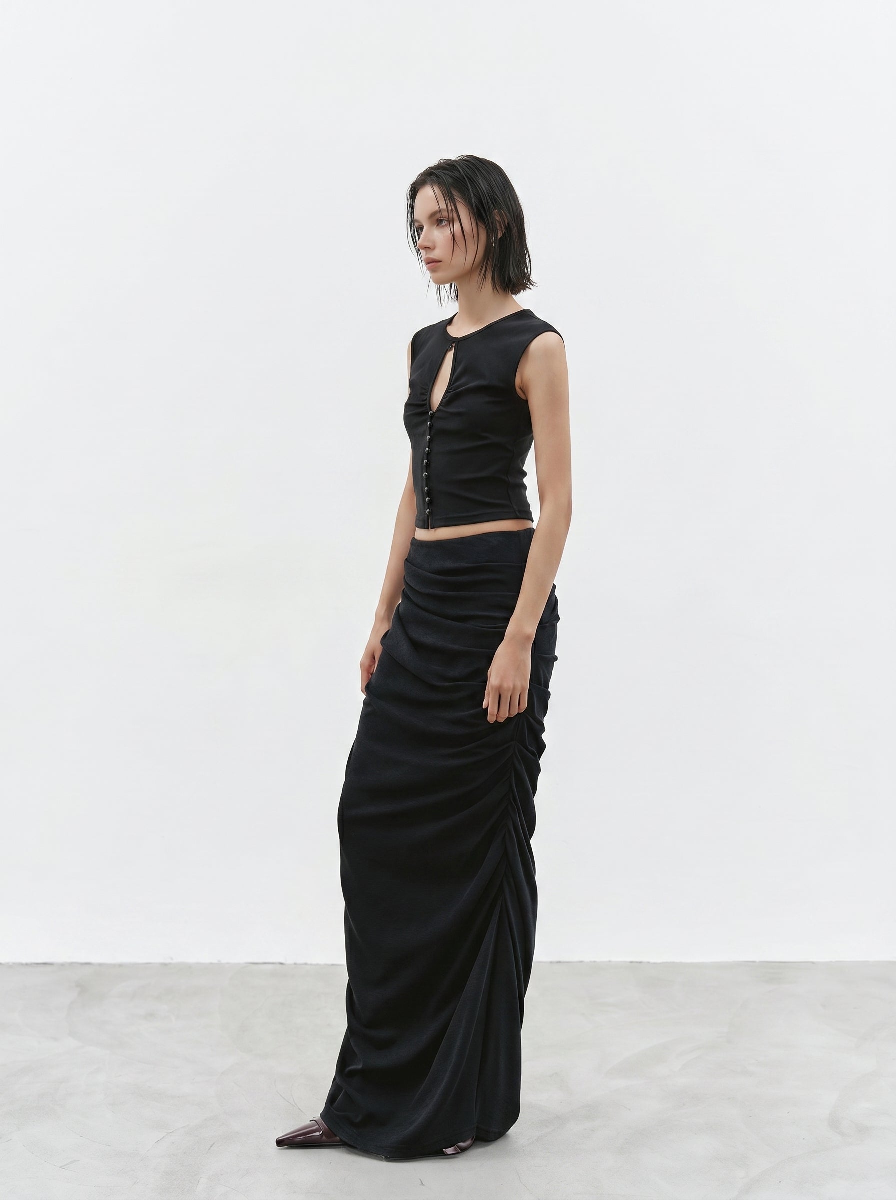 Black ruched maxi skirt side view with relaxed drape
