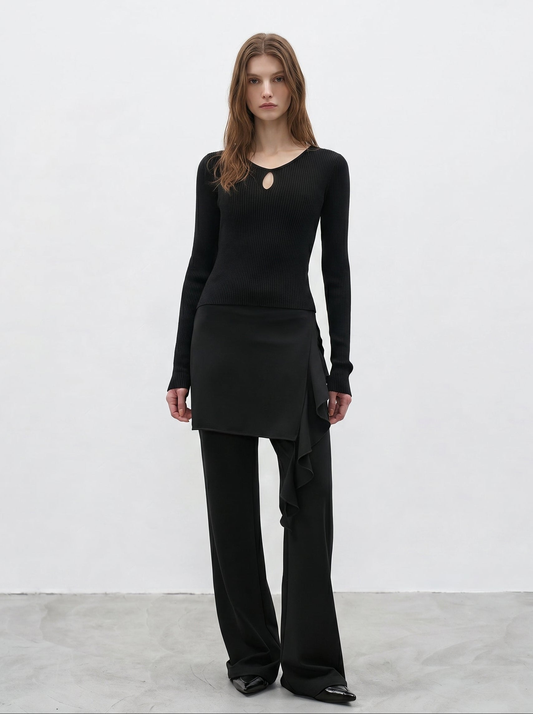 Black ruffle layered high waist flared pants styled with fitted long sleeve top