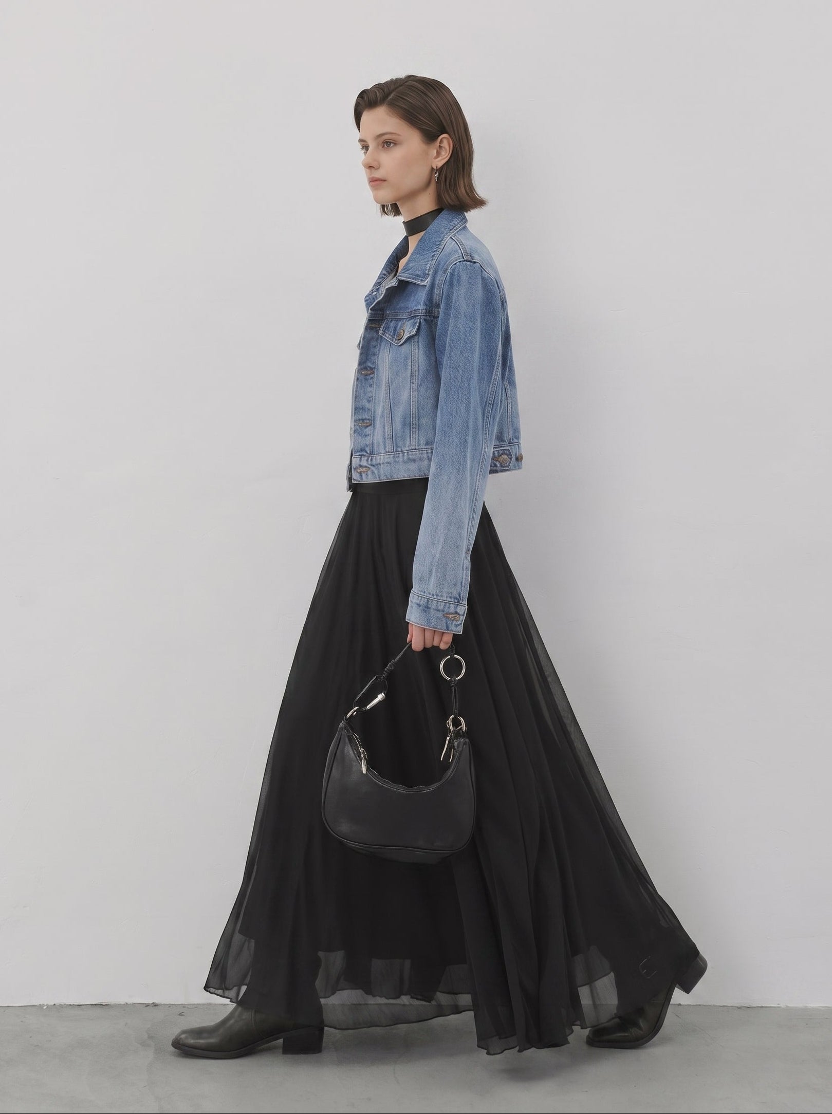 Black sheer flared maxi skirt styled with denim jacket