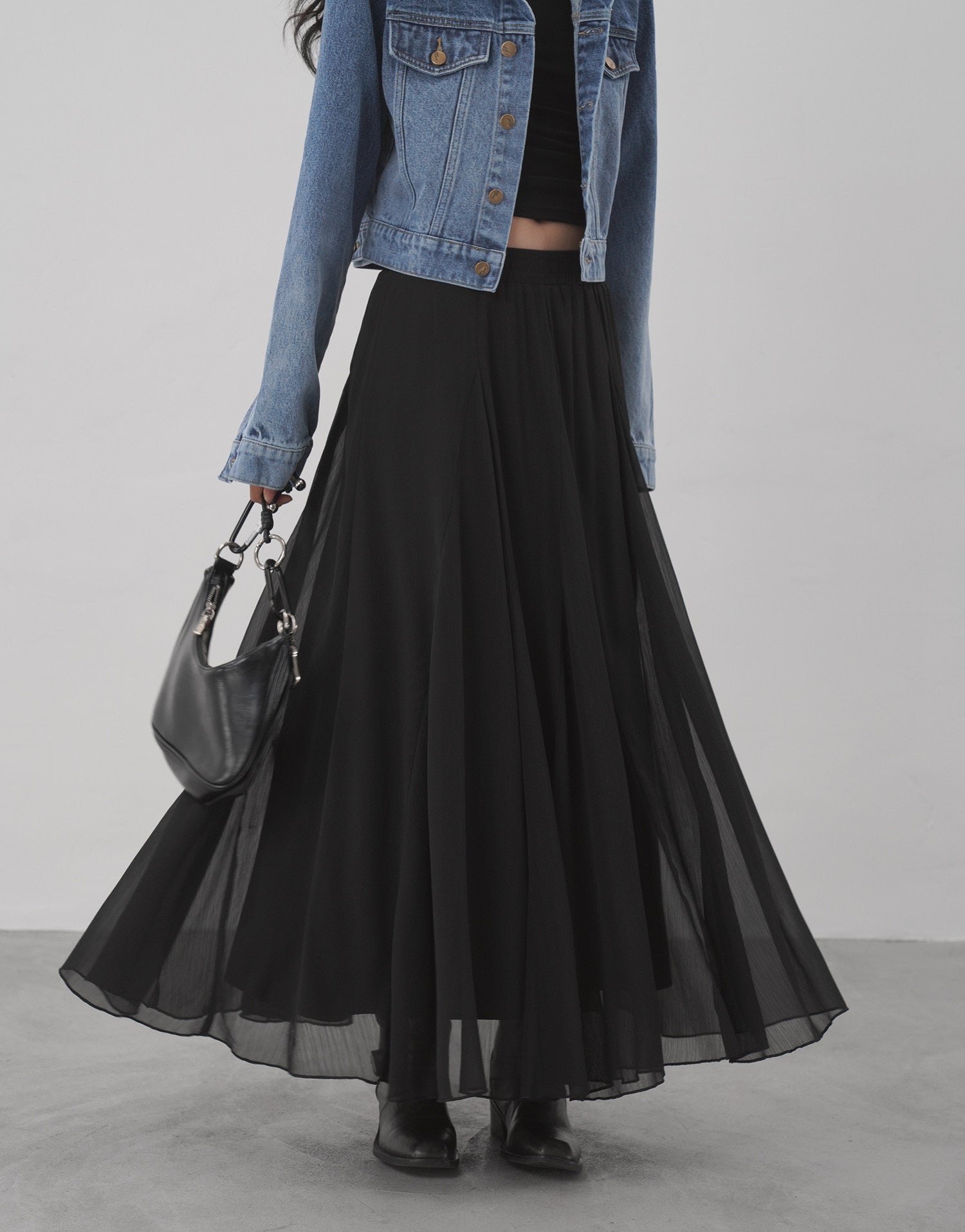 Black sheer flared maxi skirt layered look with denim jacket