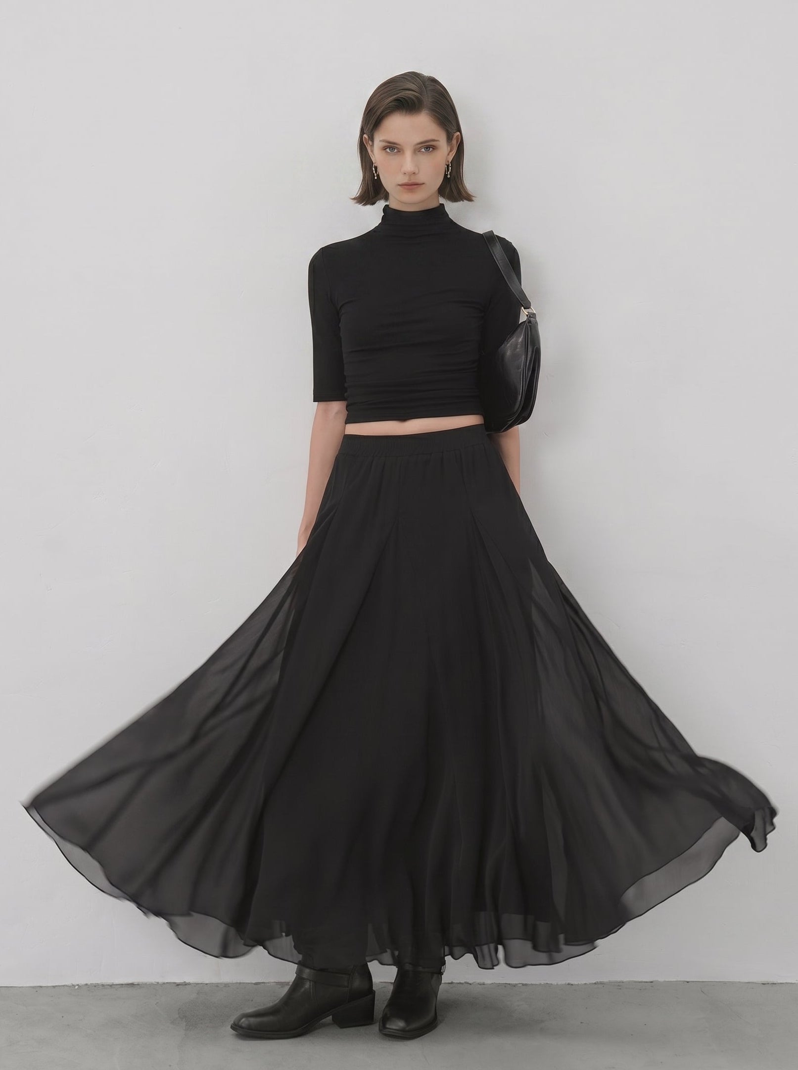 Black sheer flared maxi skirt twirl view showing flowy silhouette