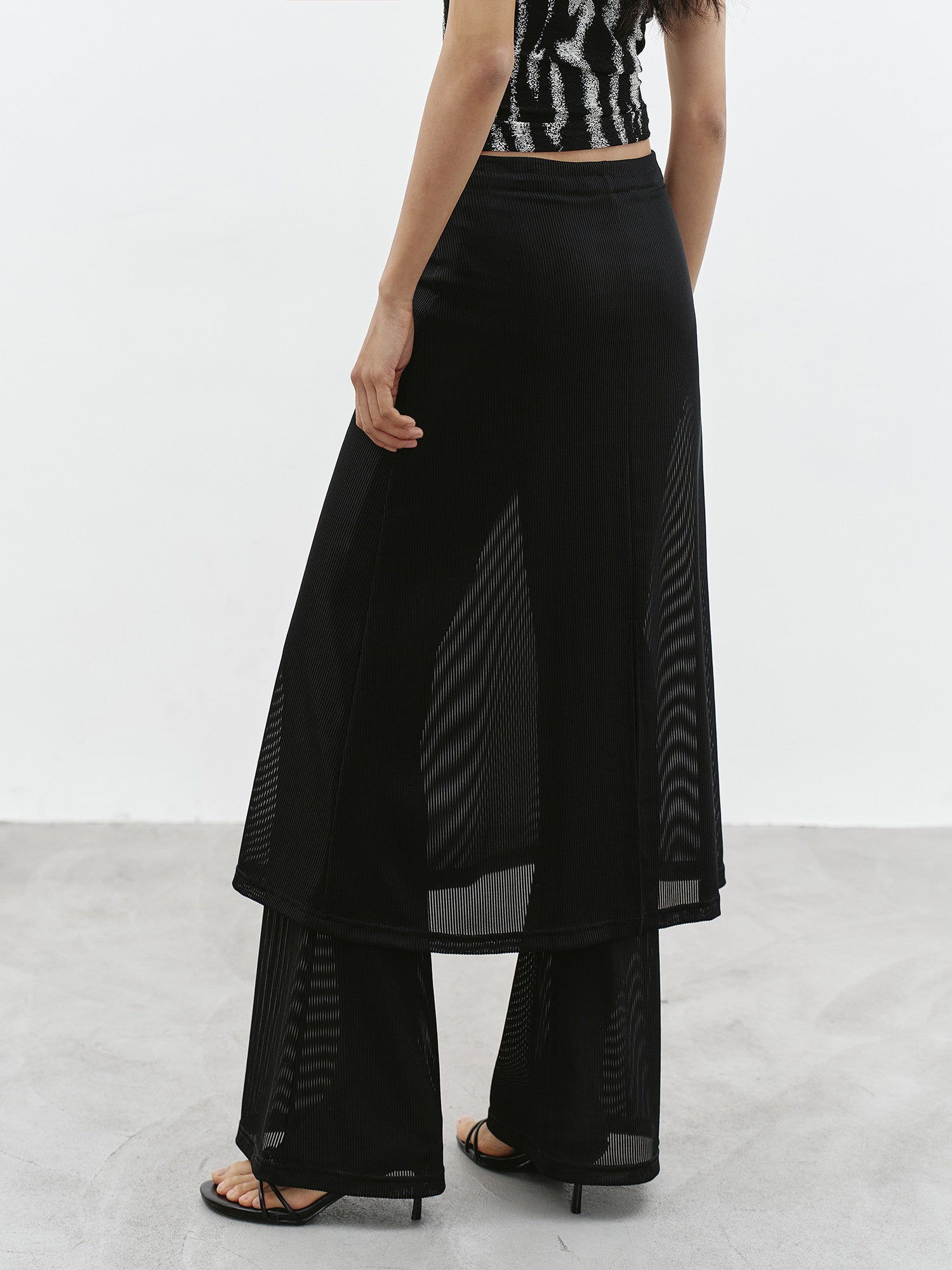 Front detail of black sheer layered maxi skirt with side slit