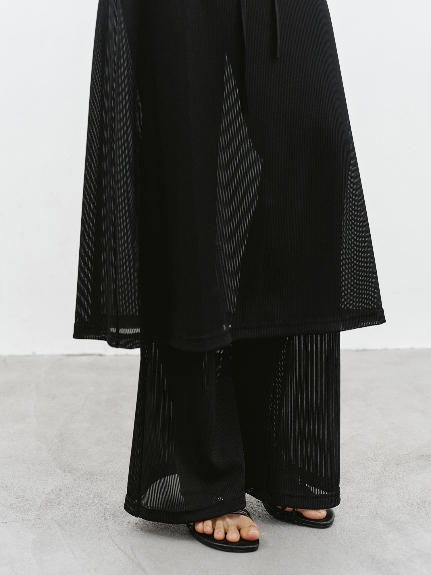 Close-up of black sheer layered maxi skirt hem and sheer fabric