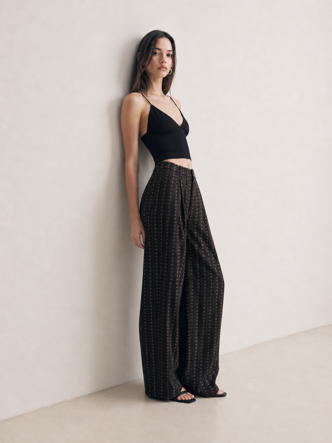 Side view of black striped wide leg pants showing the high waist and oversized wide leg drape