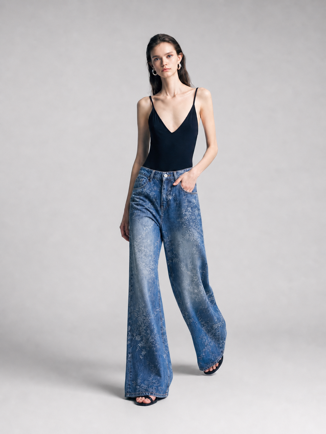 Model wearing blue jacquard wide-leg jeans, relaxed three-quarter pose.