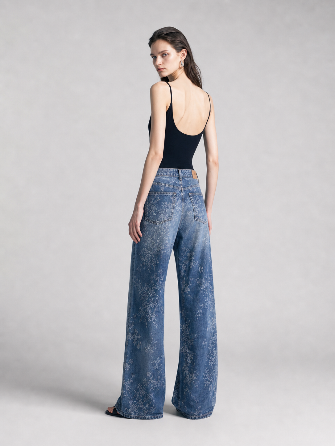 Side view of blue jacquard wide-leg jeans showing the wide-leg silhouette.