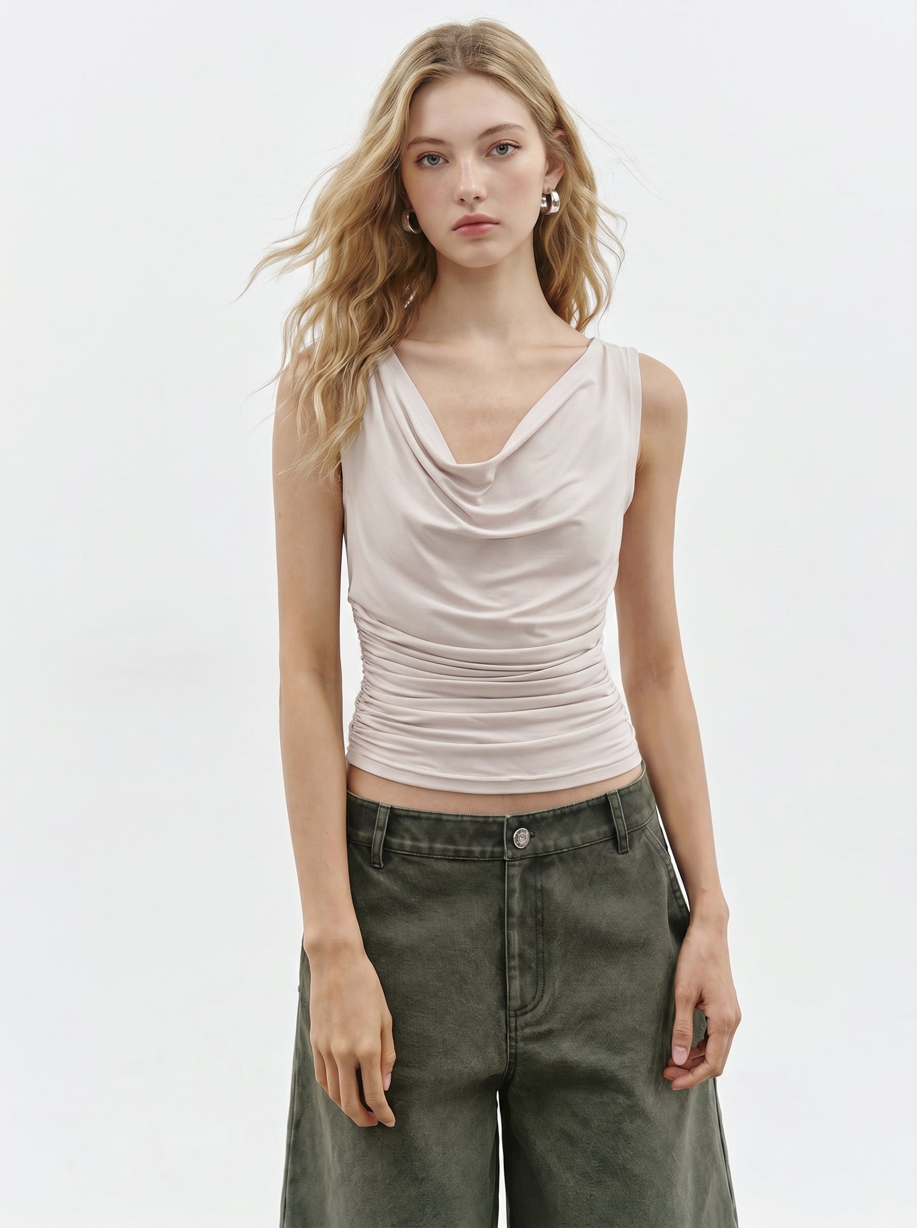 Cream cowl neck sleeveless top styled with olive cargo pants