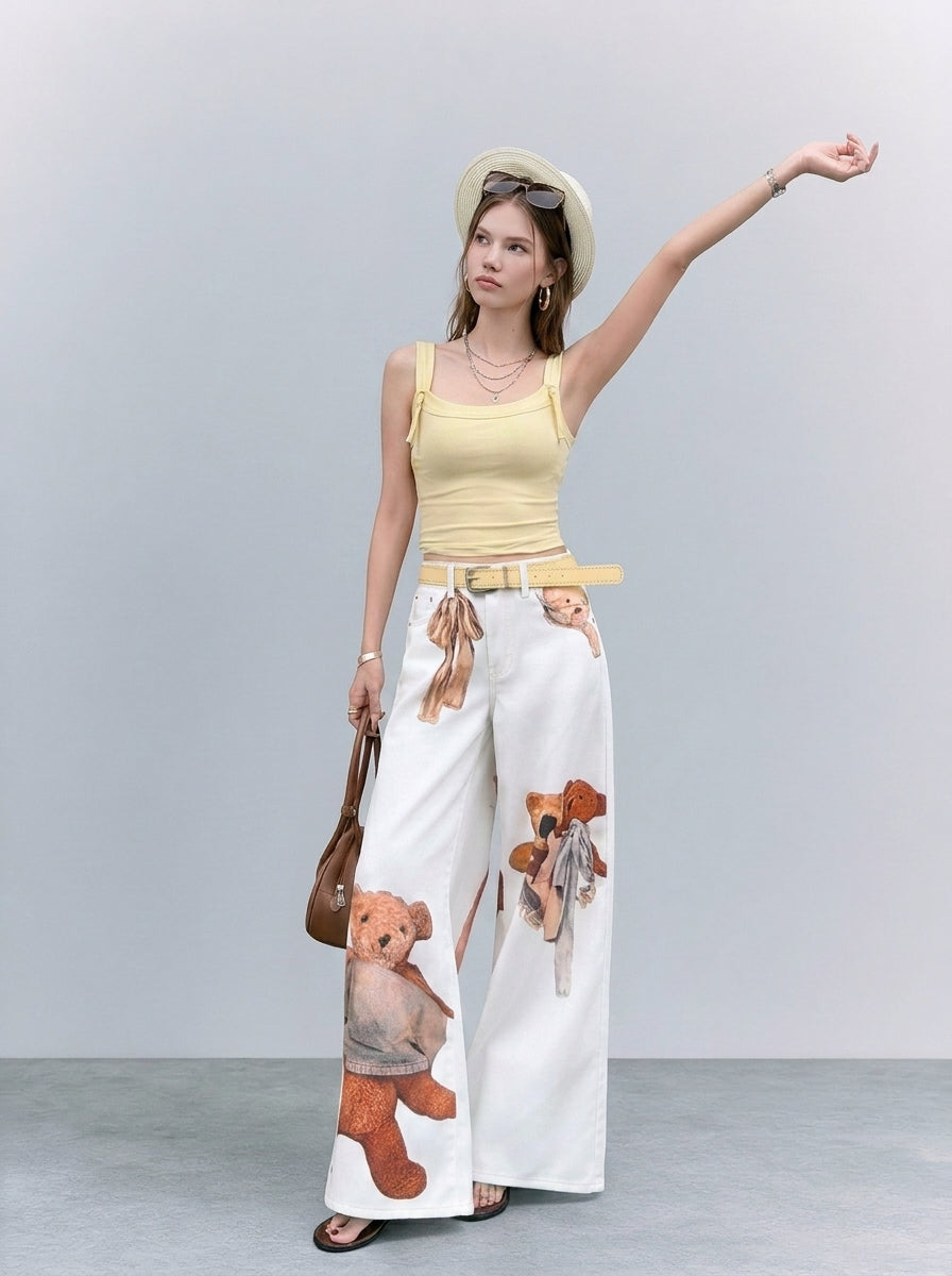Cream teddy graphic wide-leg jeans styled with yellow sleeveless top