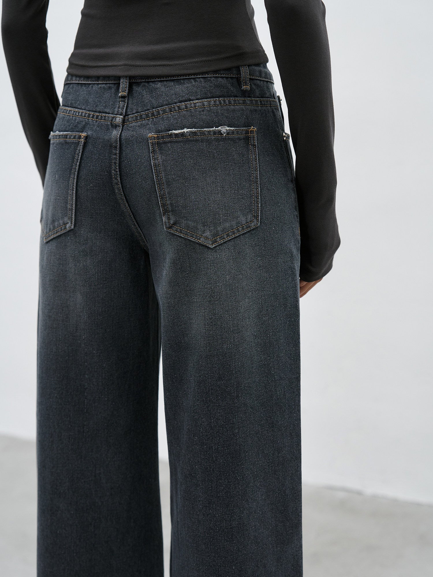Back pocket detail of dark wash wide leg jeans