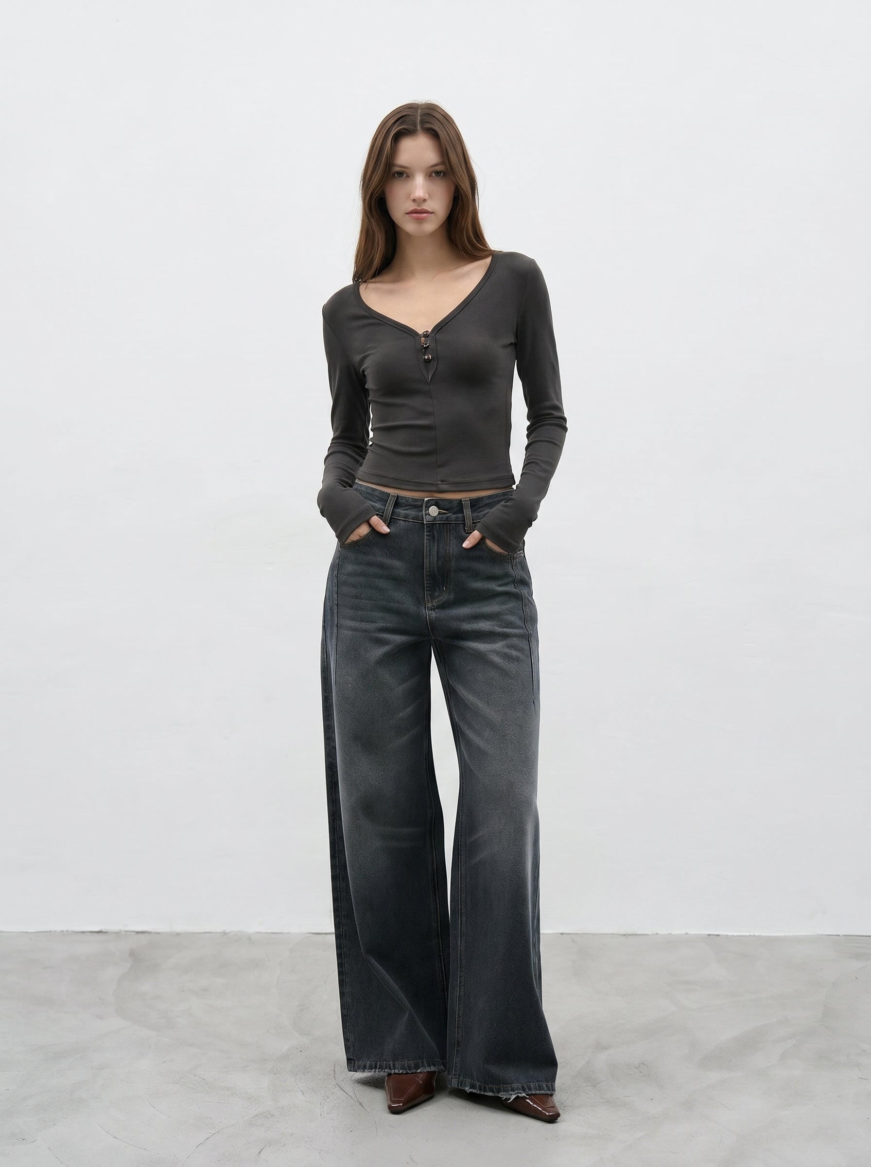 Dark wash wide leg jeans front view styled with black long sleeve top