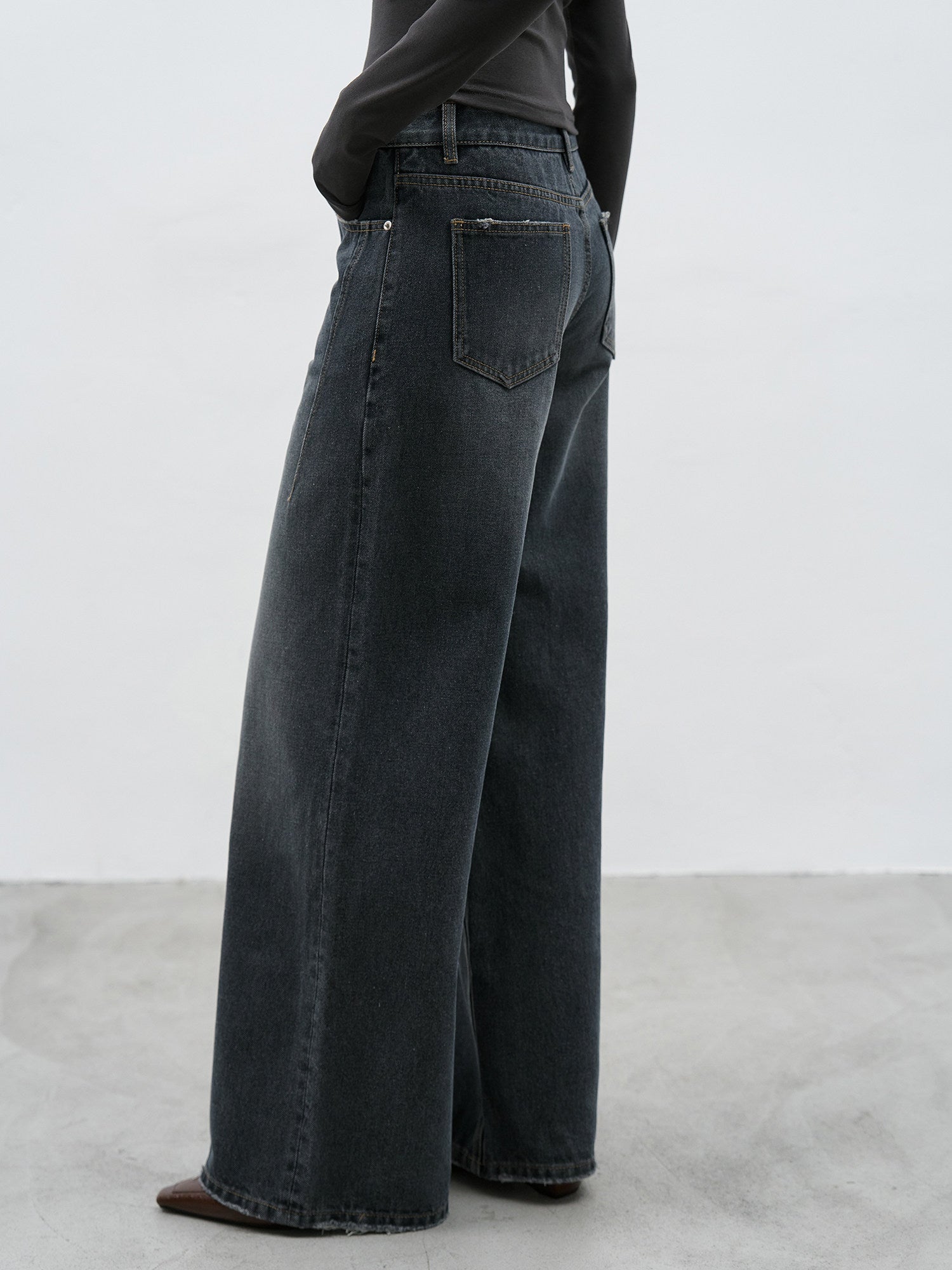 Dark wash wide leg jeans side view showing wide leg silhouette