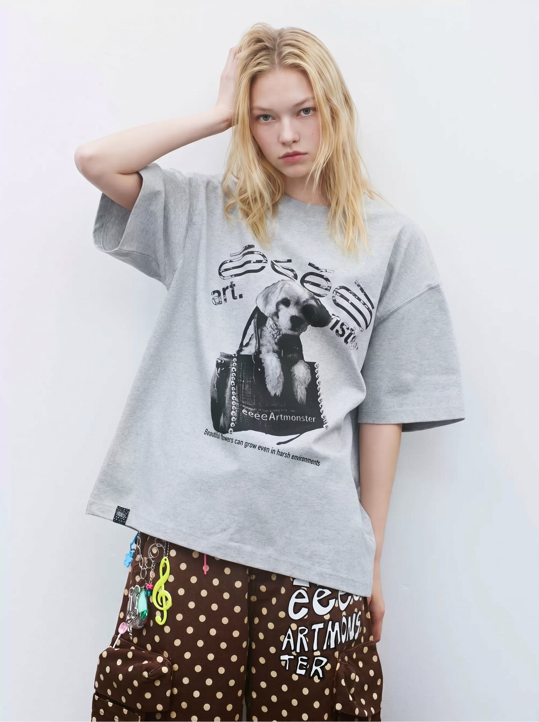 Front detail of oversized gray graphic T-shirt with black dog print and relaxed dropped shoulder sleeves