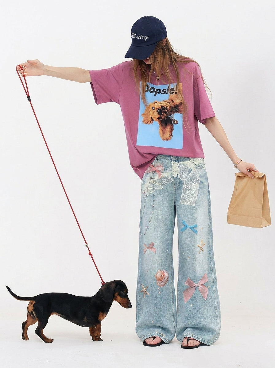 Lifestyle look of Light Blue Bow Print Wide Leg Jeans with pink graphic tee
