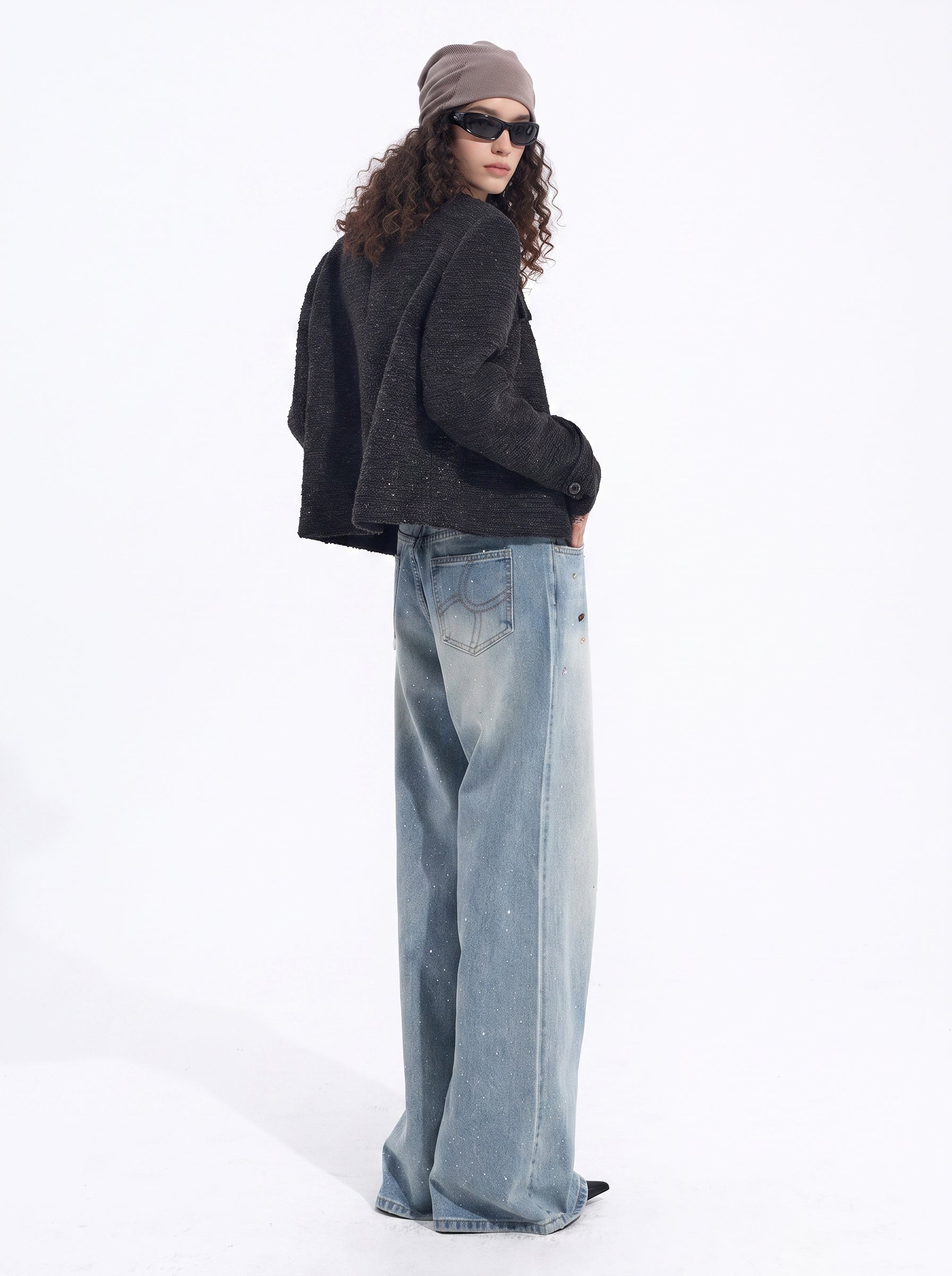 Back view of light blue wide-leg jeans showing the loose silhouette and full-length design