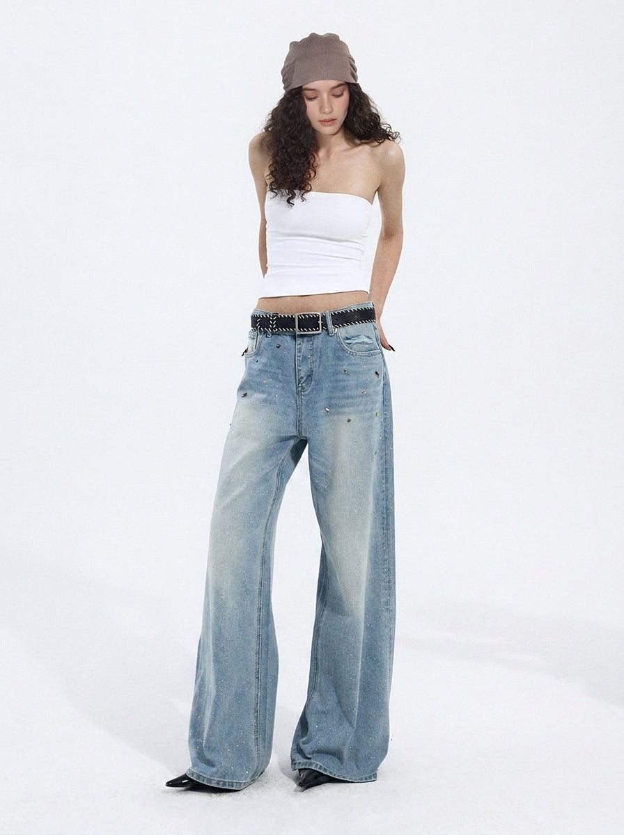 Model wearing light blue wide-leg jeans with a relaxed fit and casual white crop top