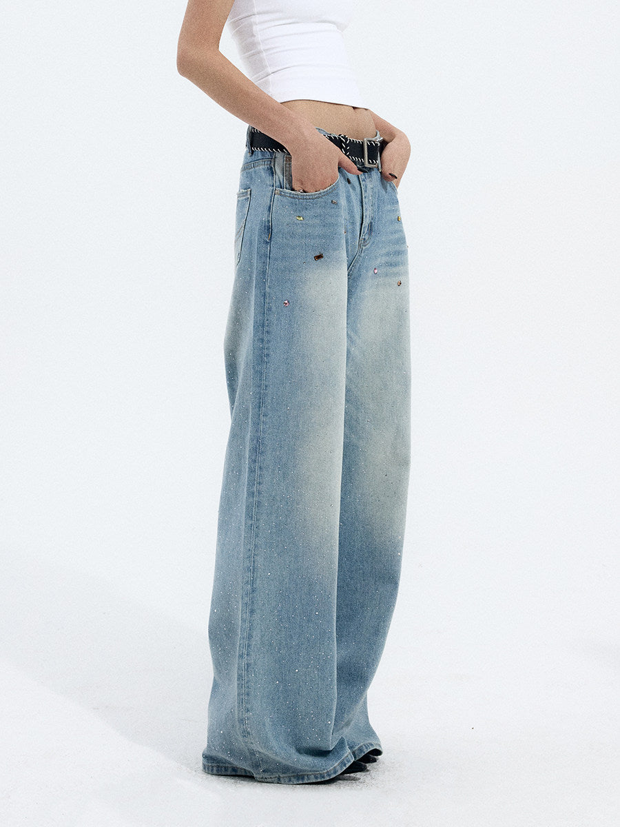 Side view detail of light blue wide-leg jeans showing the curved waistband and relaxed leg shape