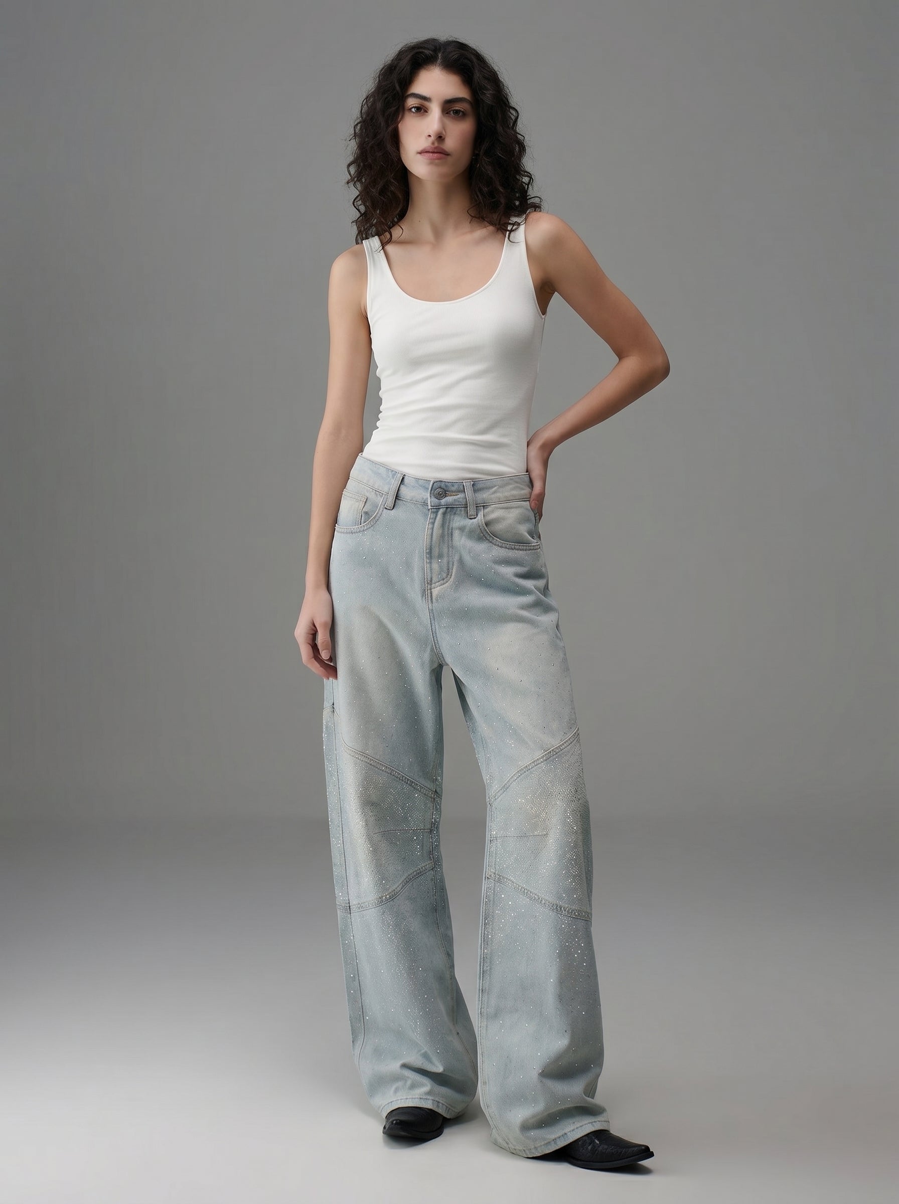 Front view of light wash rhinestone wide leg jeans styled with a white fitted T-shirt