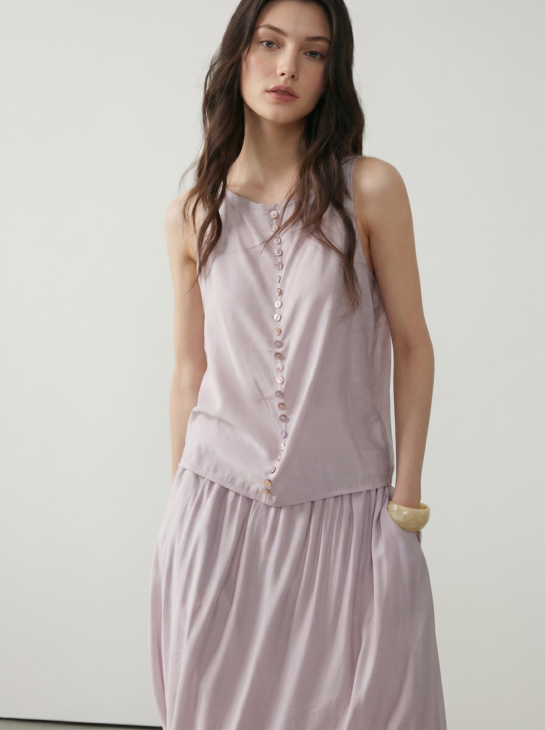Front detail of pale blush sleeveless button tank with pearl-style buttons and matching gathered skirt