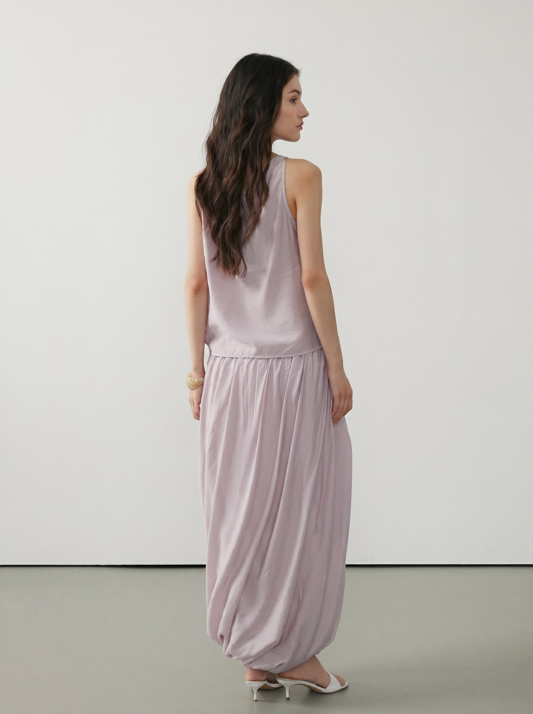 Back view of pale pink sleeveless tank and matching draped maxi skirt with soft gathered fabric