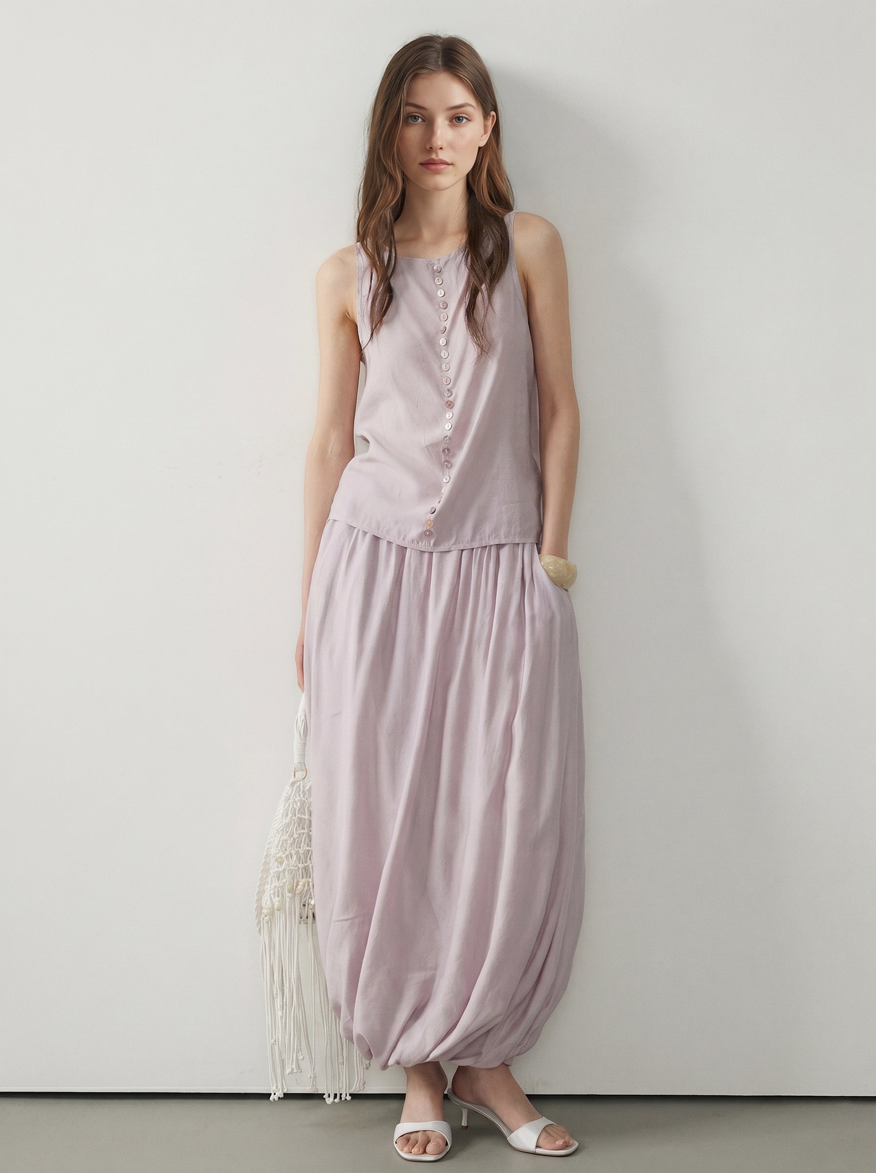 Pale pink sleeveless button tank styled with a matching draped maxi skirt and white sandals
