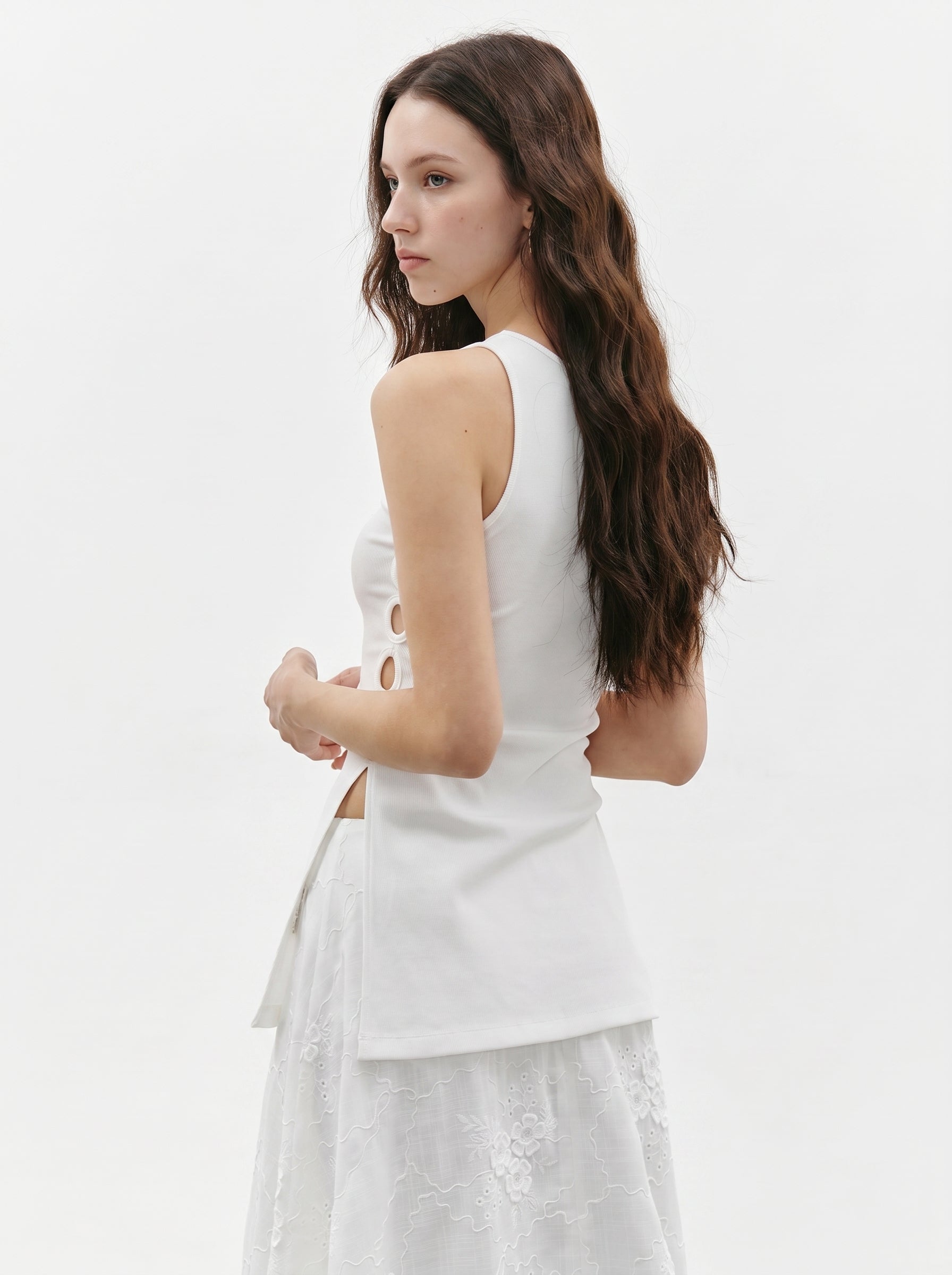Back angled view of white side ring ribbed tank top showing the sleeveless silhouette and side cutout detail