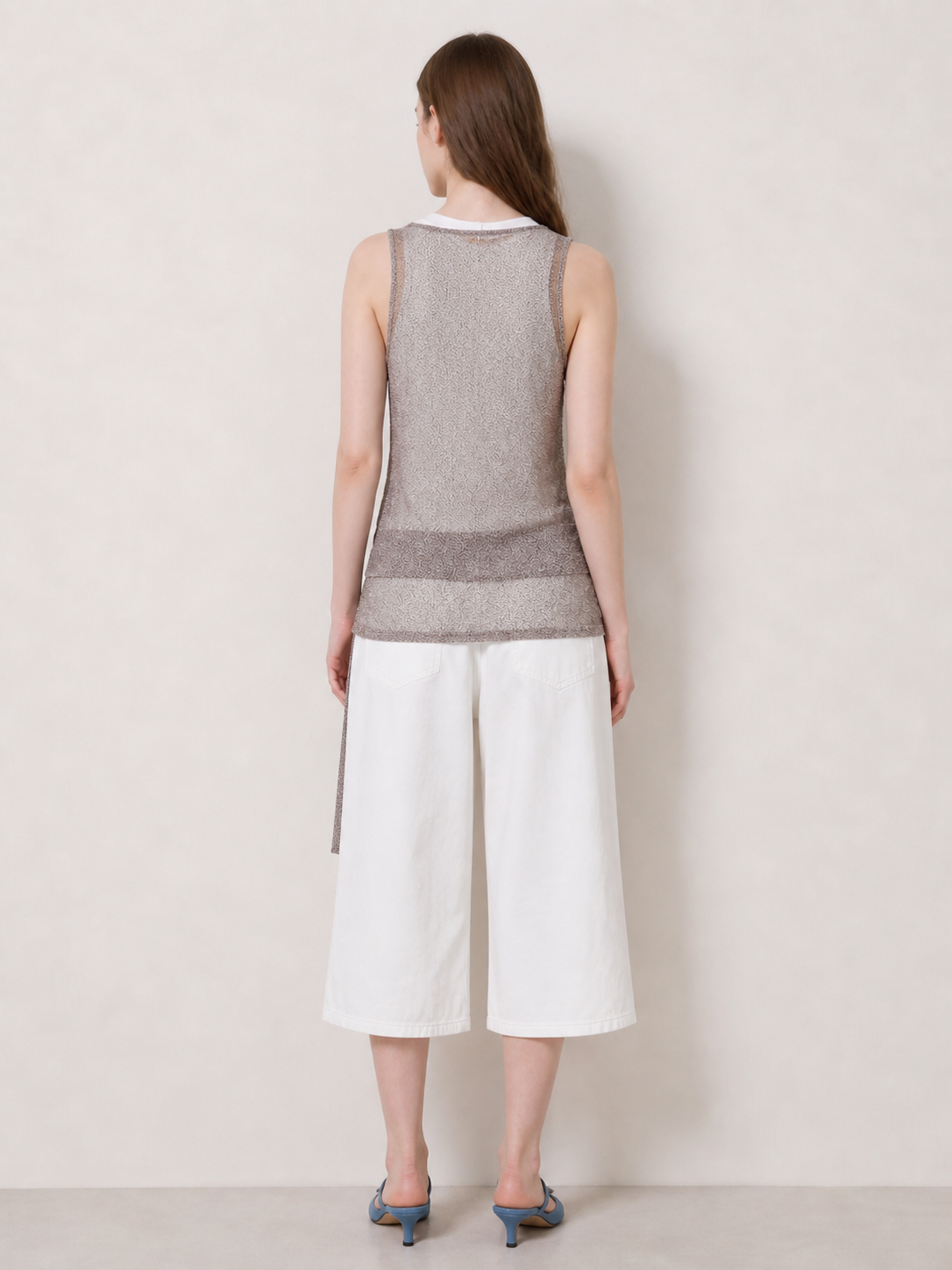view.jpg
Back view of taupe sleeveless knit tank layered over a white tank with white cropped wide leg pants