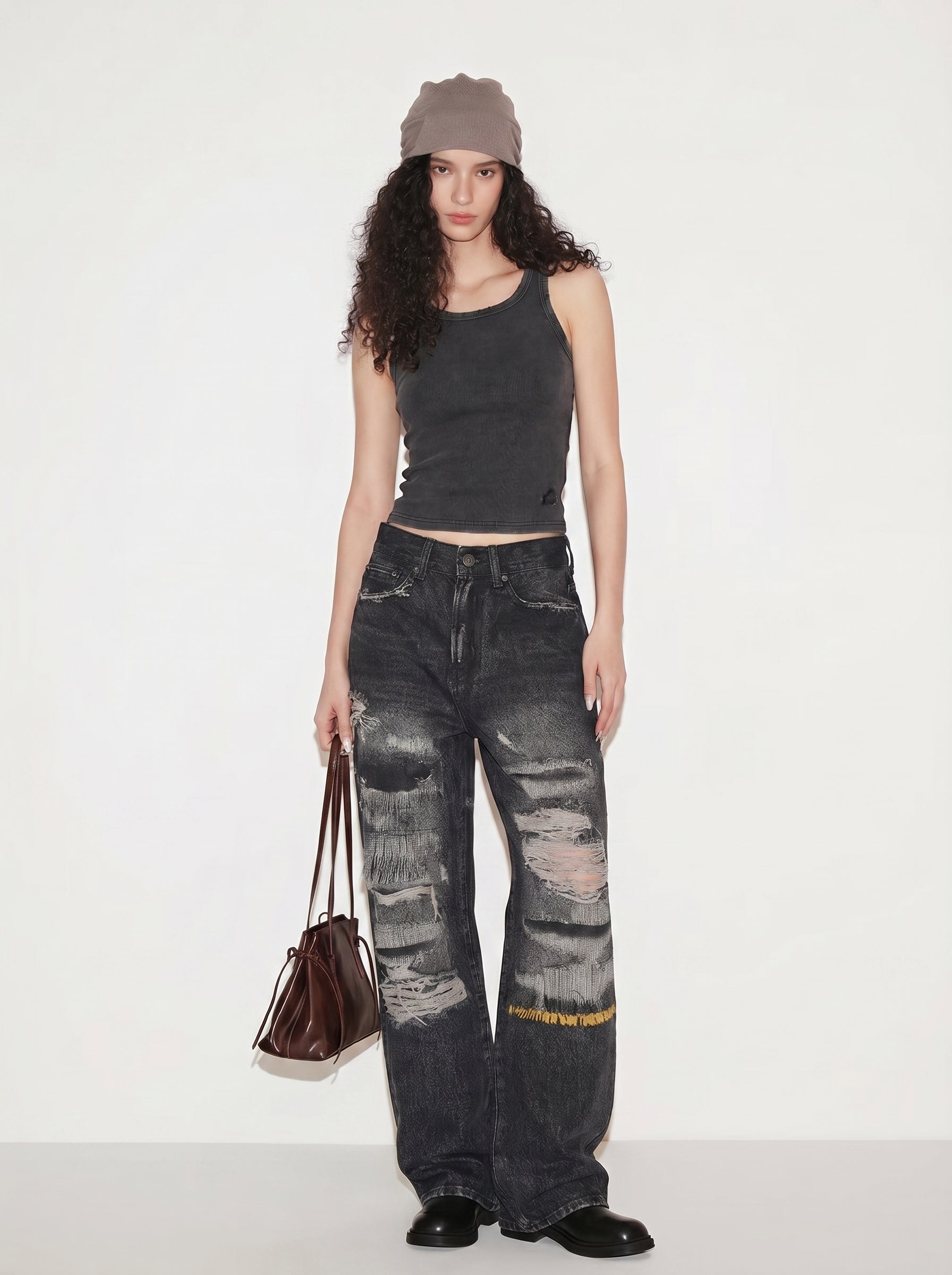 Vintage washed ripped baggy jeans styled with a charcoal tank top