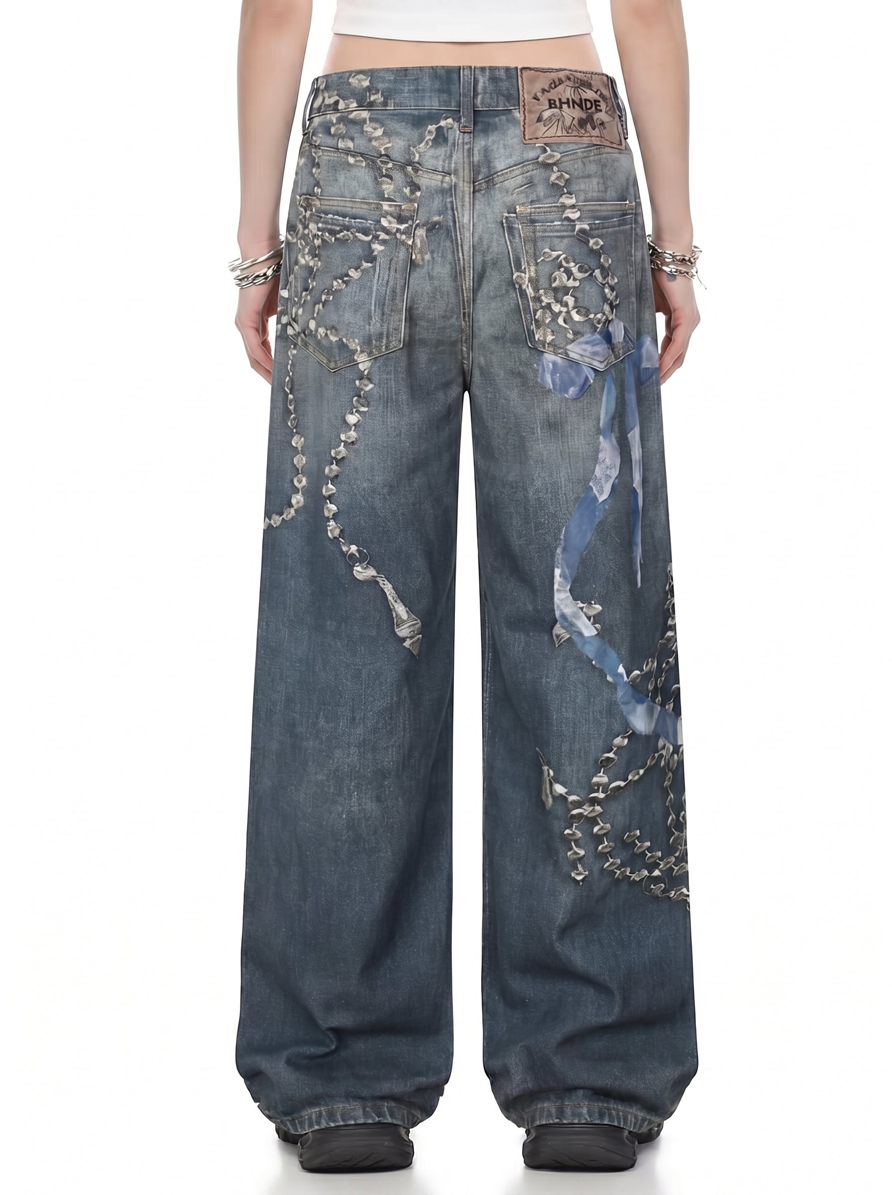 Back view of washed blue chain graphic wide-leg jeans