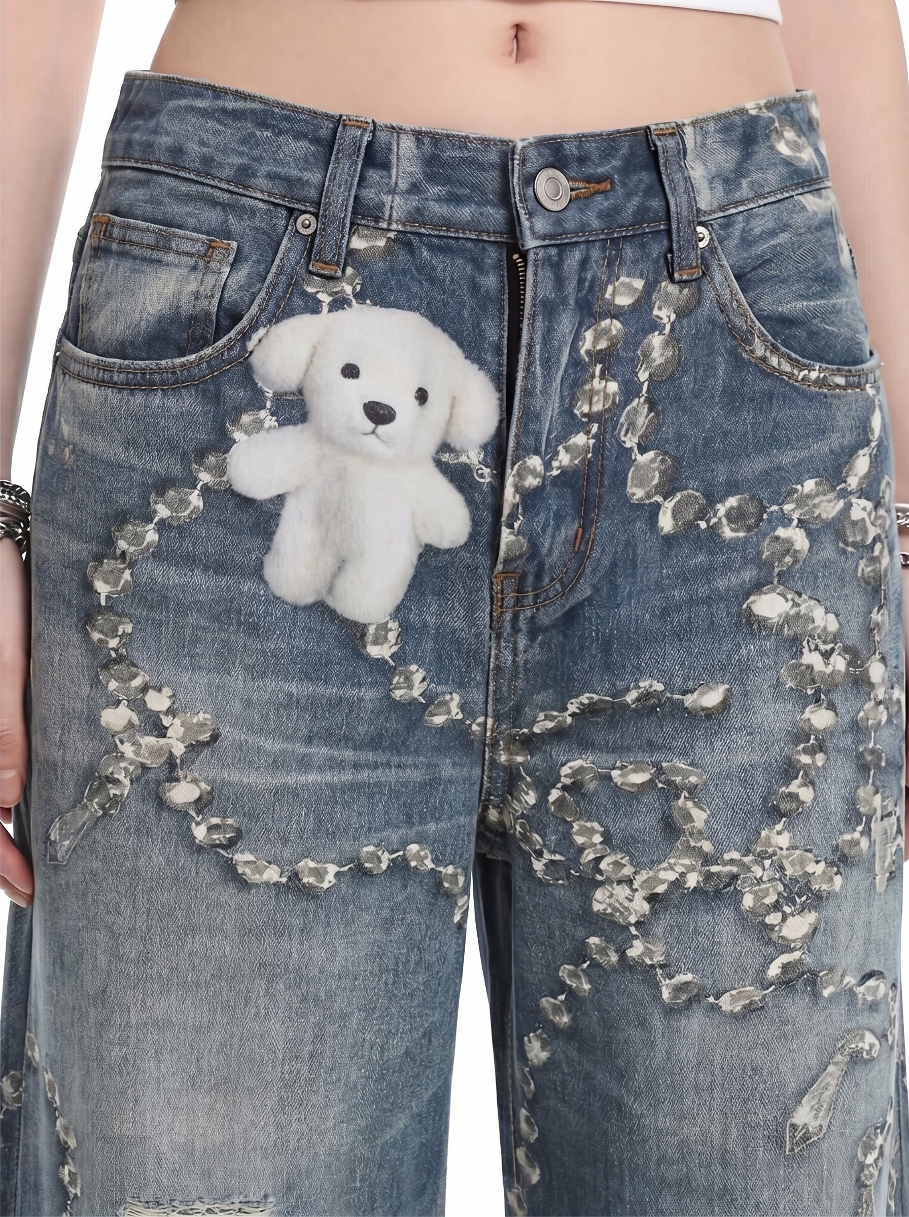 Detail view of washed blue chain graphic wide-leg jeans