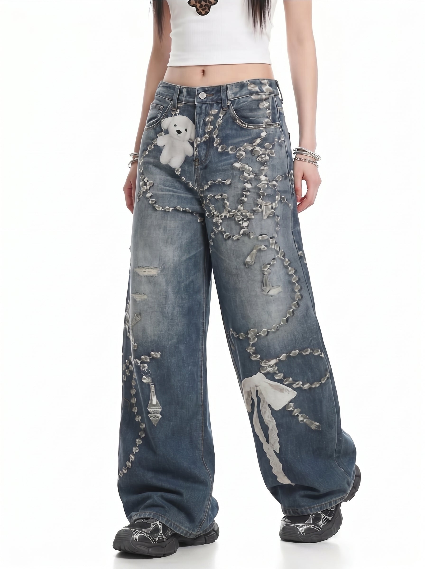 Front angle view of washed blue chain graphic wide-leg jeans