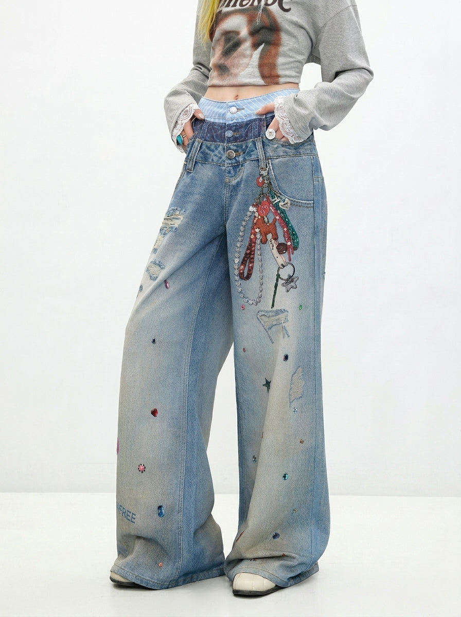 Graphic print and wide leg detail of Washed Blue Layered Waist Graphic Wide Leg Jeans