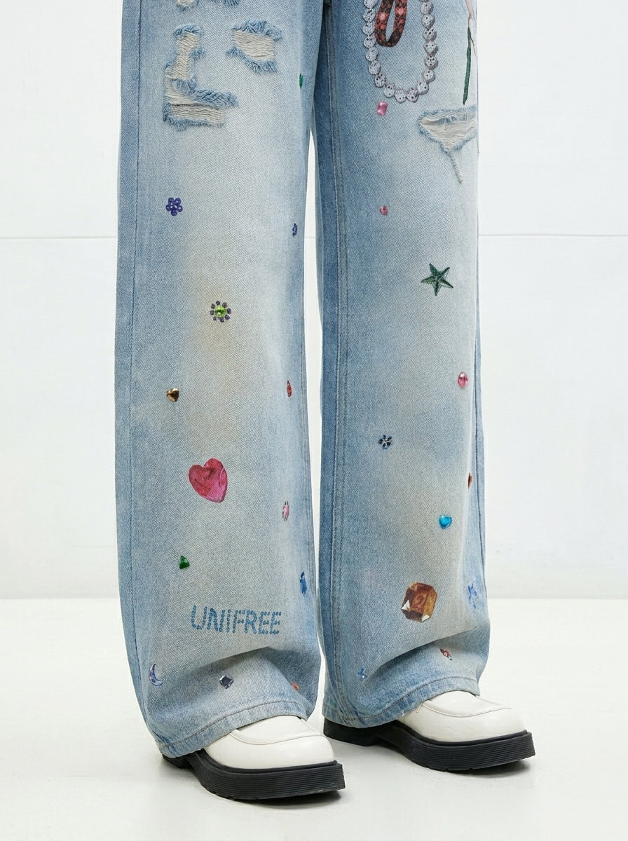 Graphic print and wide leg detail of Washed Blue Layered Waist Graphic Wide Leg Jeans